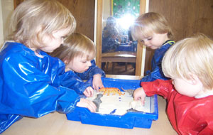 children playing and helping at the school